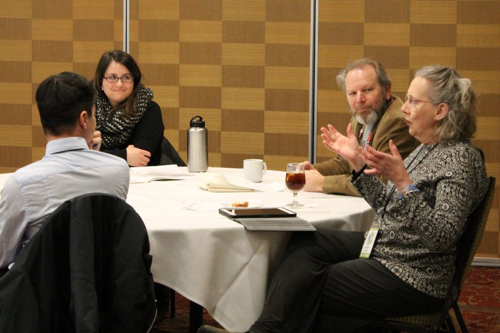 Conference attendees chatting around a table